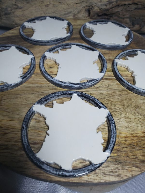Sous-verres en céramique artisanaux représentant la carte de France, élégants et uniques, parfaits pour une décoration raffinée et pratique.