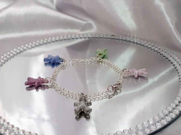 Bracelet artisanal avec figurines en céramique en forme de petits bonhommes, idéal pour un style original et ludique.