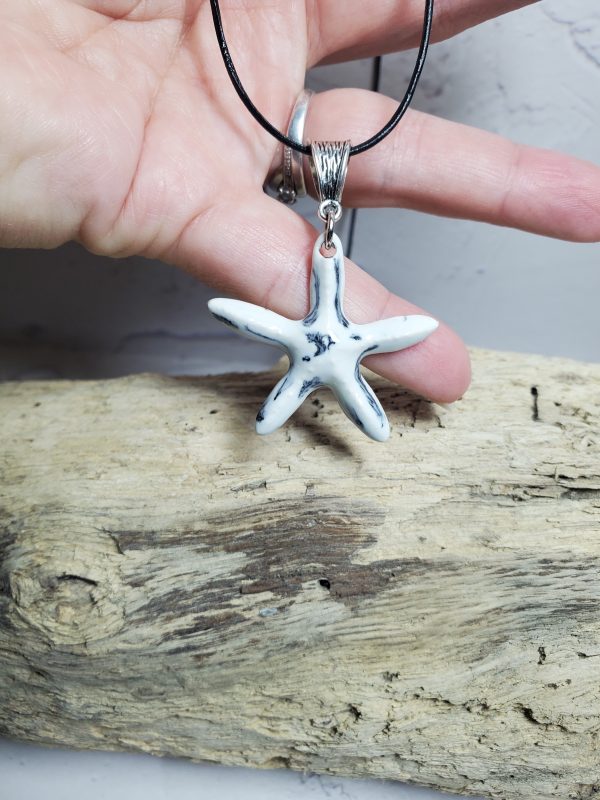 Pendentif en céramique en forme d'étoile de mer, fait main, élégant et unique, parfait pour offrir ou compléter une tenue estivale. Disponible sur Only Ceramic Creation.